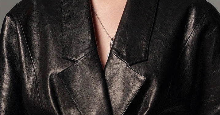 Close-up shot of the low-notch lapels and tailored collar tailoring on the glazed goatskin wrap jacket — From Borcelleclothes.