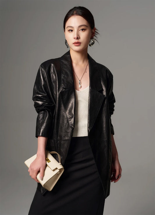 Model wearing the glazed goatskin nappa wrap jacket in Vola Con Me, holding a white bag — From Borcelleclothes.