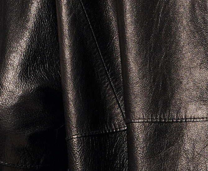 Close-up texture of glass-glazed goatskin nappa leather showing natural grain and liquid sheen in Vola Con Me — From Borcelleclothes.