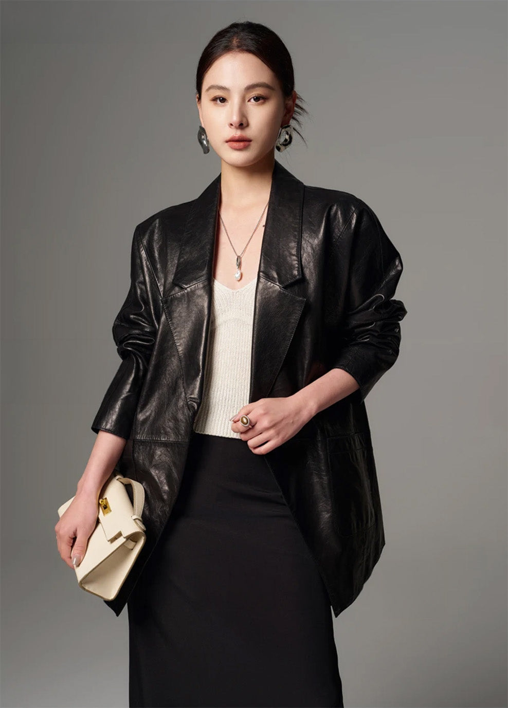 Front view of model facing camera in the open glazed goatskin jacket revealing draped front panels — From Borcelleclothes.