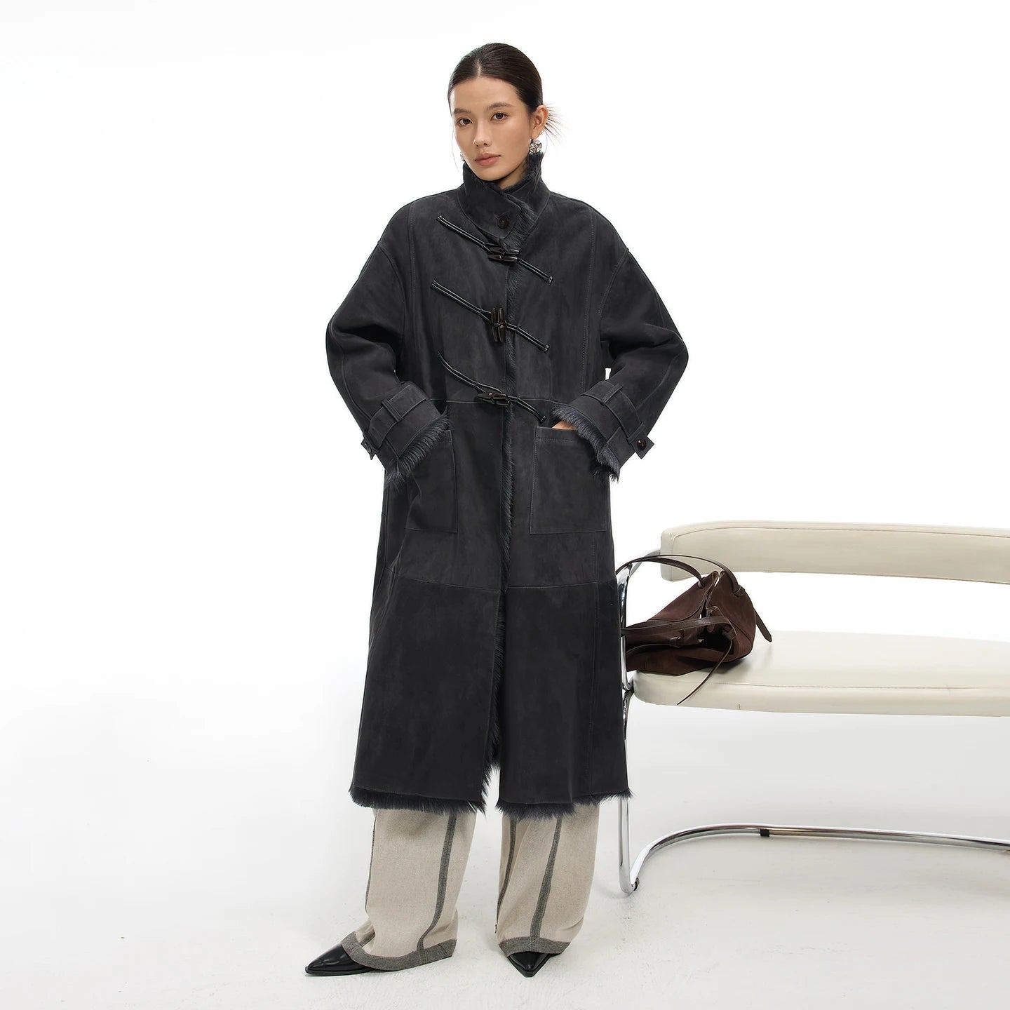 Women's mid-calf goatskin coat in Inner Depth, with toggle closure on the diagonally arranged leather air loops; Toscana fur visible at uncut edges — From Borcelleclothes.