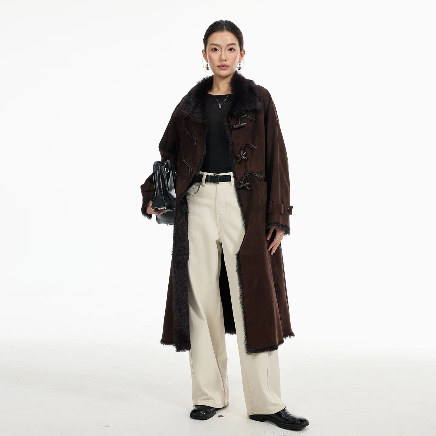 Women's mid-calf goatskin coat in Wenge, with toggle closure on the diagonally arranged leather air loops; Toscana fur visible at uncut edges — From Borcelleclothes.