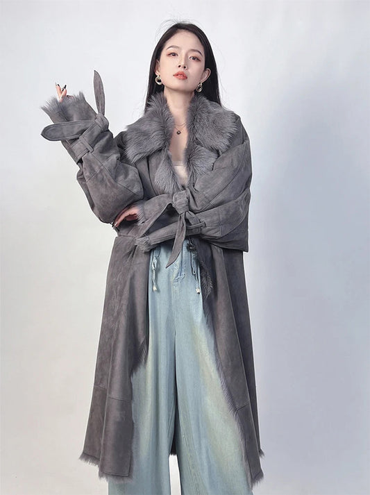 Woman wearing Dark Horse goatskin coat with one arm raised and elbow bent — From Borcelleclothes.