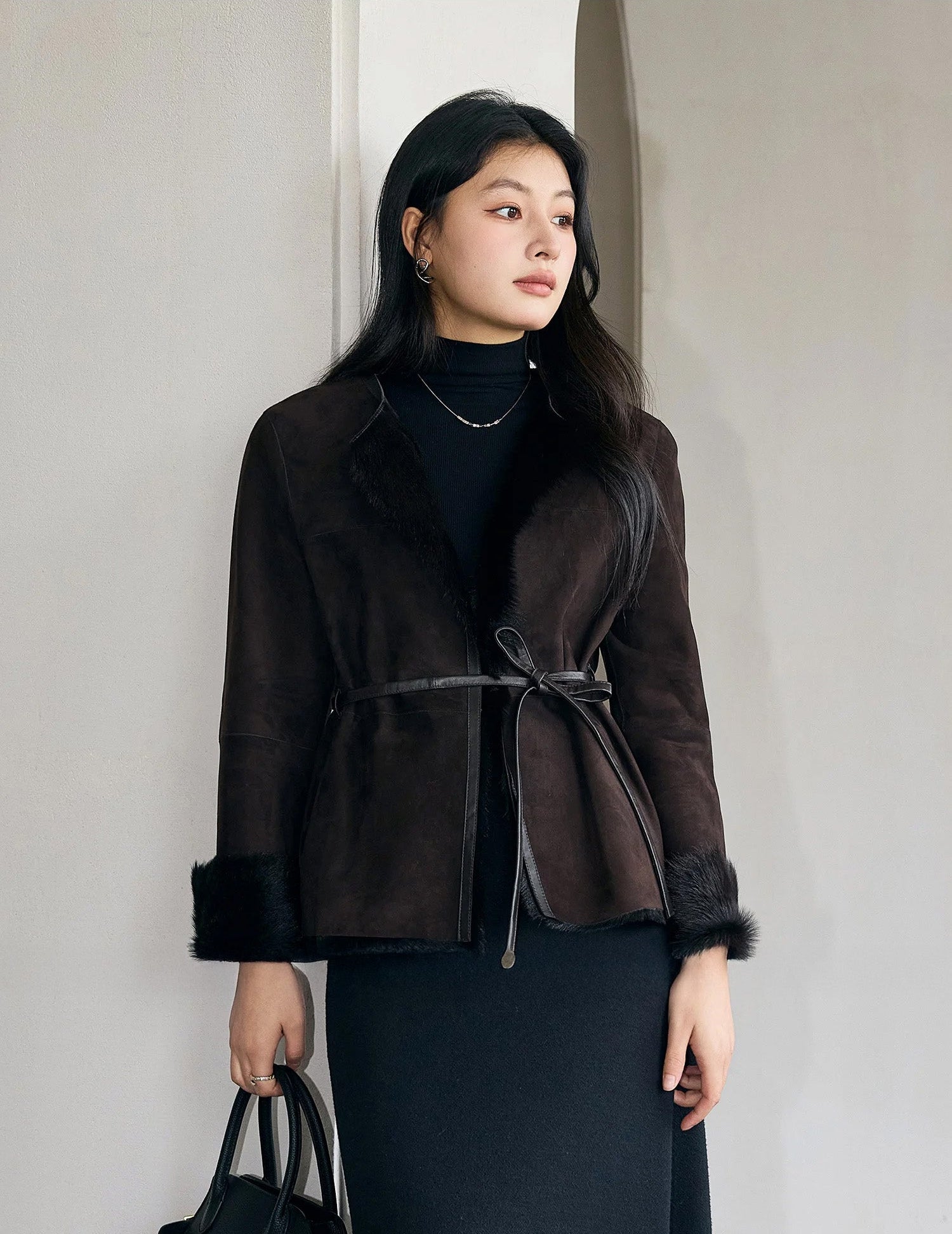 Side profile of the Tamarind goatskin jacket with clean-cut seams and subtle inner wool detail — From Borcelleclothes.