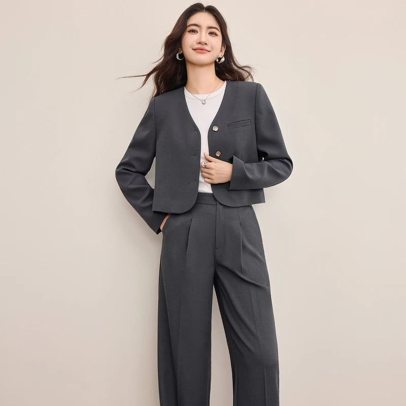 Gris Phénix set: a grey cropped single-breasted jacket with rounded edges and molten metal buttons paired with straight-cut pleated trousers. — From Borcelleclothes.