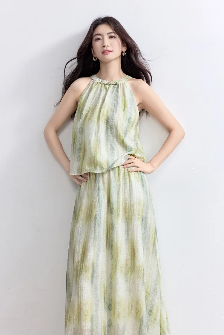 A woman posing with hands on her hips, demonstrating the elegant silhouette and fit of the halter neck set — From Borcelleclothes.