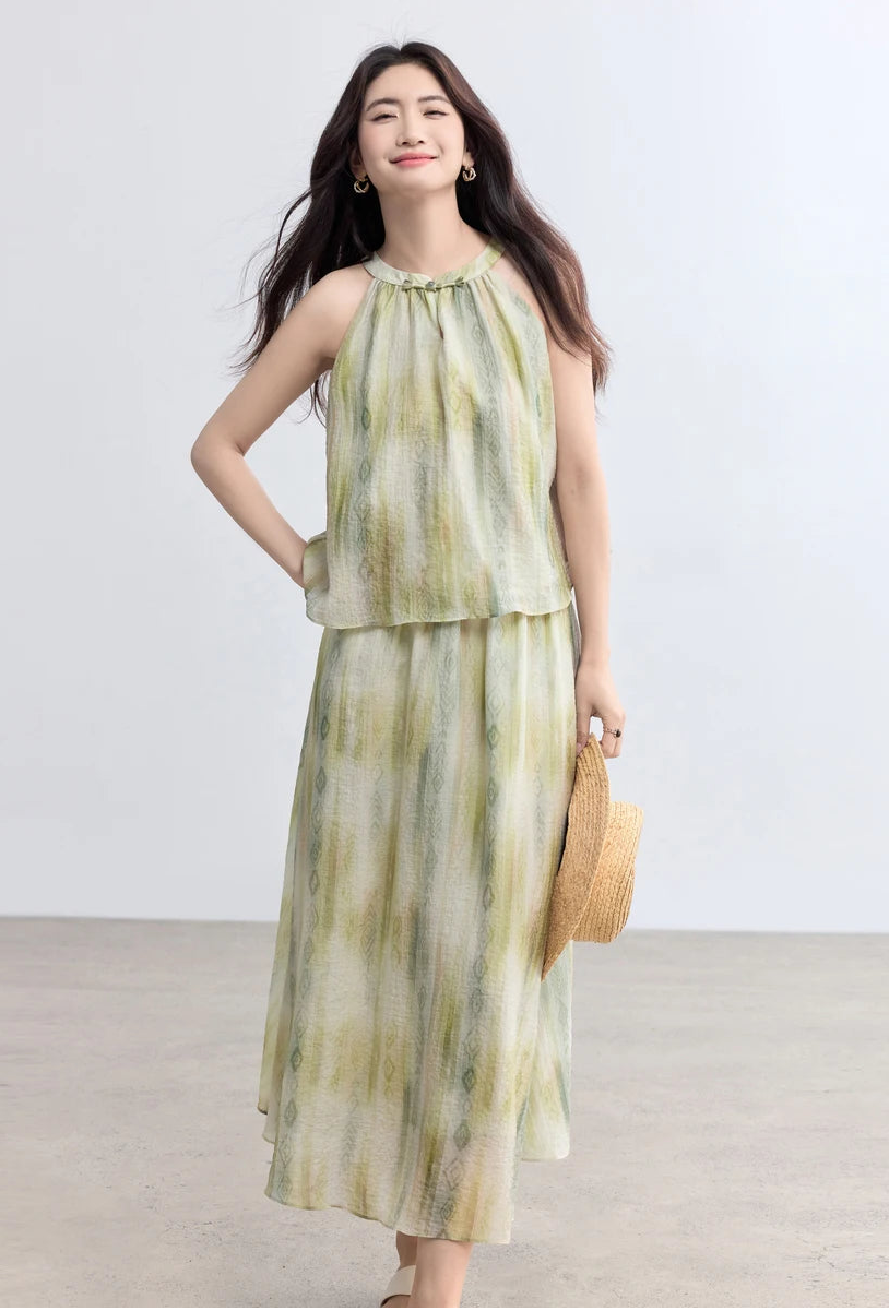 A woman in the Inner Charm set holding a straw hat, evoking a sense of effortless summer elegance — From Borcelleclothes.
