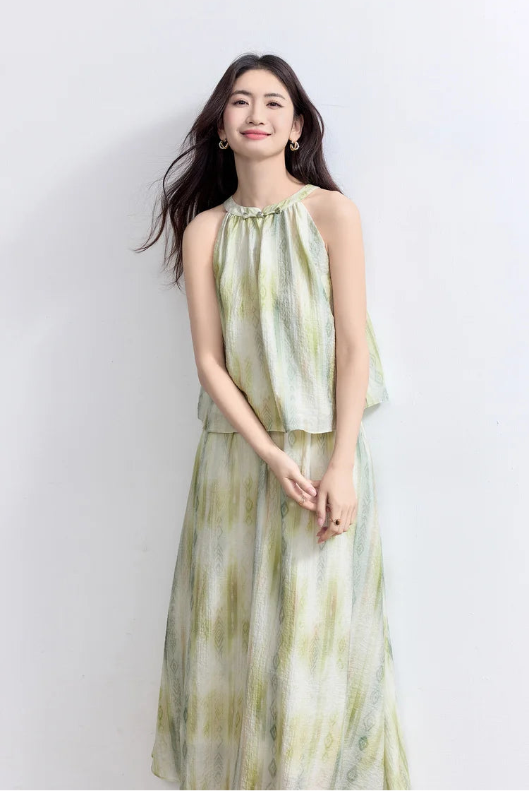 A woman gently touching her fingertips, showcasing the fluid drape of the Inner Charm lyocell halter neck top — From Borcelleclothes.