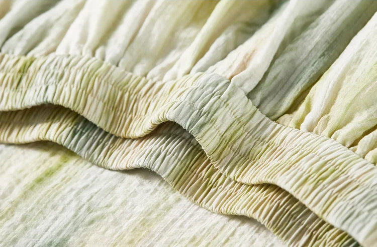 Close-up of the elasticated waistband on the flared midi skirt, emphasizing the crinkled texture — From Borcelleclothes.