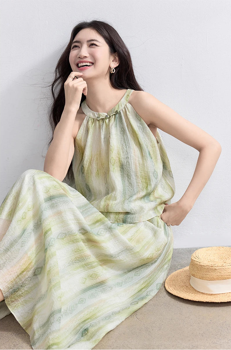 A smiling woman sitting gracefully on the floor in the Inner Charm crinkled set, highlighting the soft watercolor olive gradient — From Borcelleclothes.