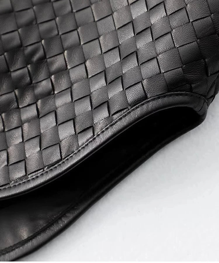 Close-up of curved bottom hem with leather-bound edges on woven sheepskin jacket — From Borcelleclothes.