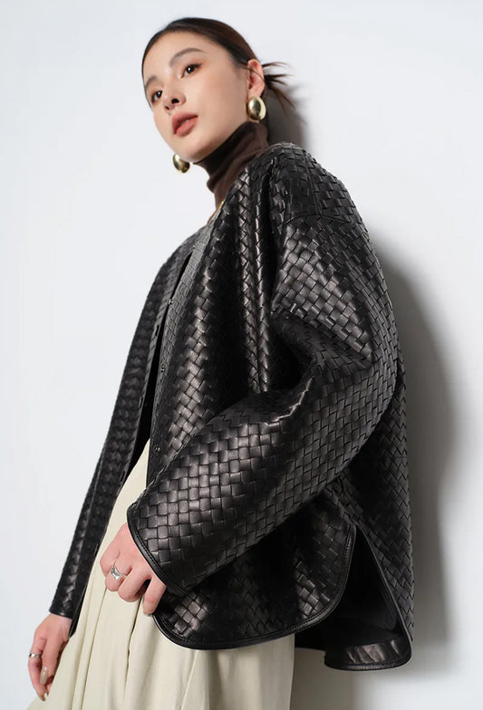 Model wearing hand-woven sheepskin nappa jacket in Quicksilver Noir leaning against wall — From Borcelleclothes.