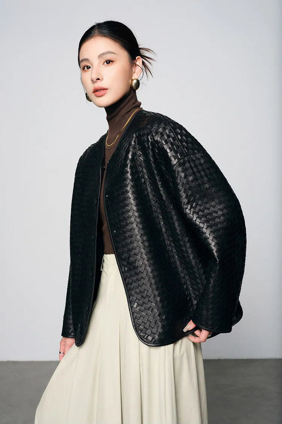 Side profile of model walking in relaxed-fit woven sheepskin jacket — From Borcelleclothes.