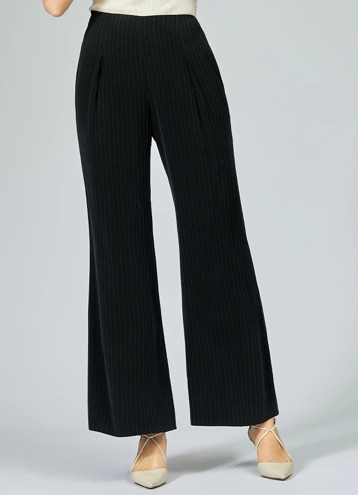 Woman wearing heavyweight silk trousers posing with one foot stepped to the side — From Borcelleclothes.