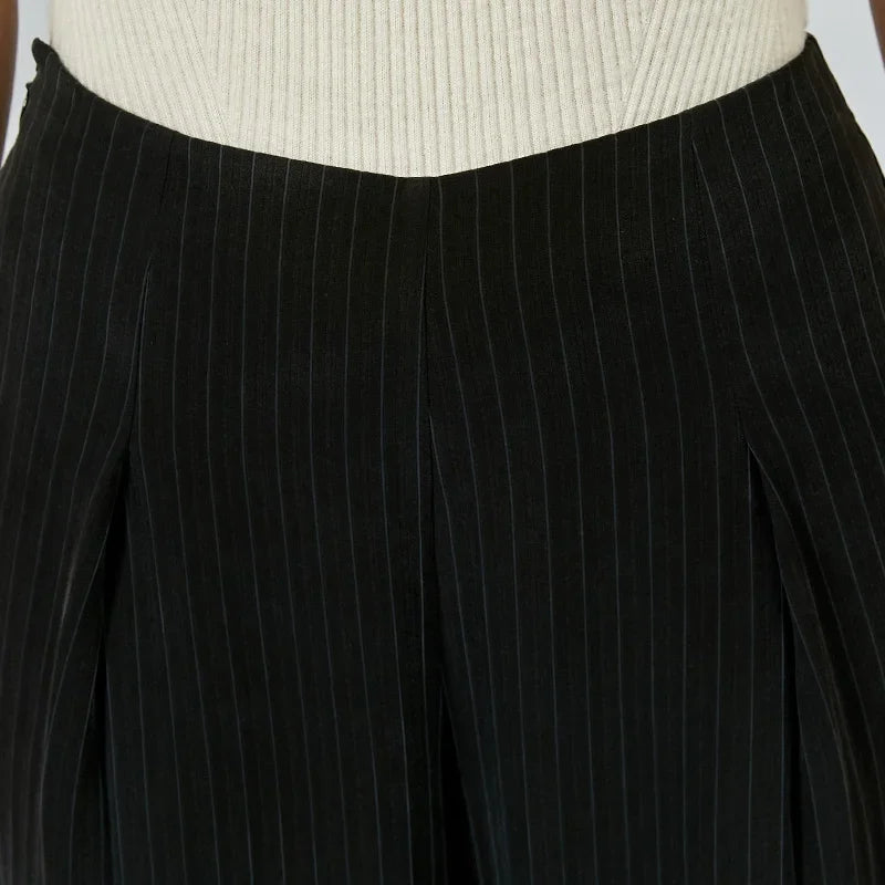 Front view of the waist section and box pleats on women's pinstripe silk trousers — From Borcelleclothes.