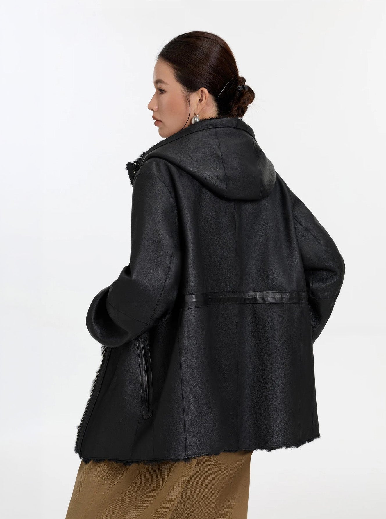 Model facing back, Night Swirling coat, leather side — From Borcelleclothes.
