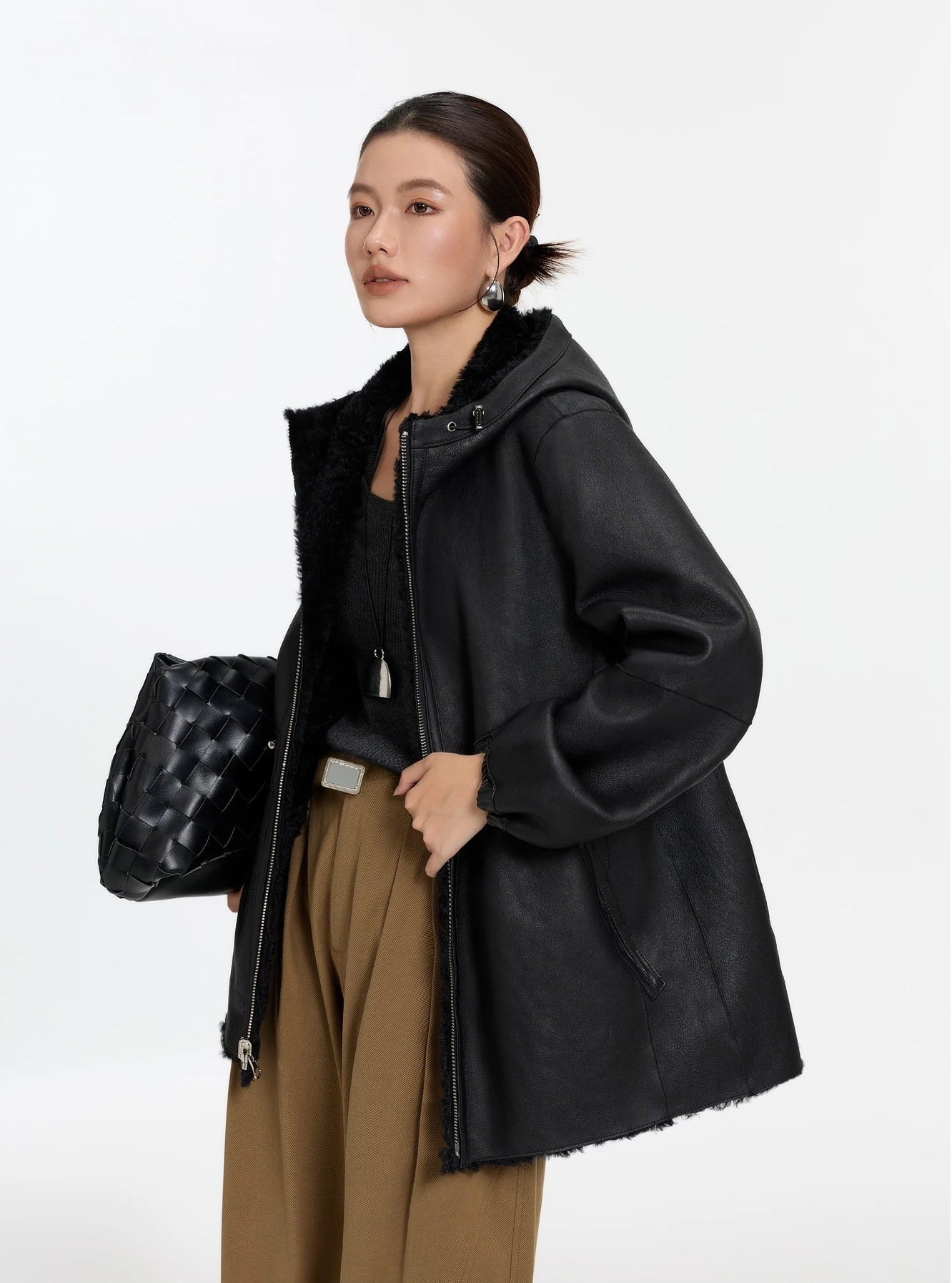 Model turned slightly to the side, Night Swirling coat, leather side — From Borcelleclothes.