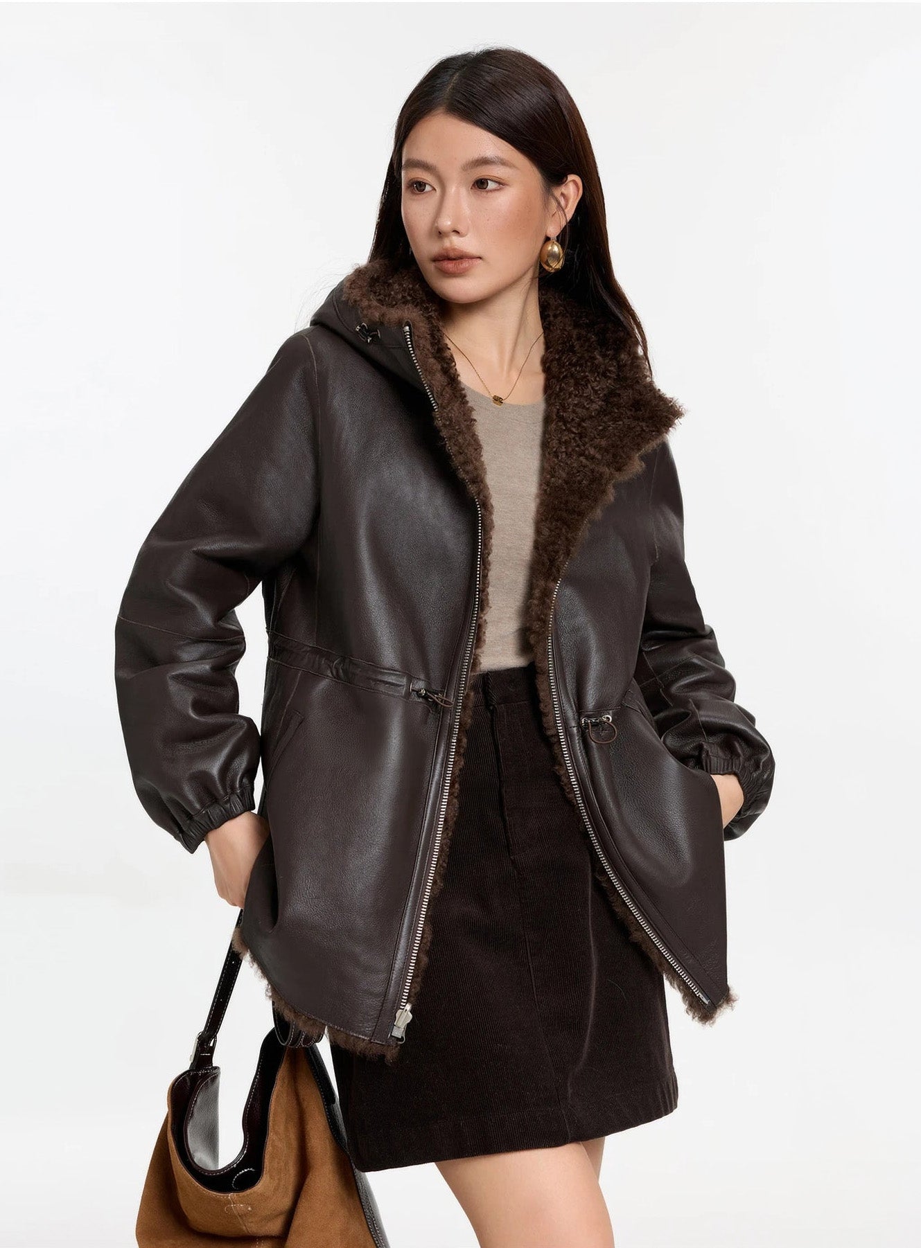 Model holding a bag, Toffee Bloom coat, leather side — From Borcelleclothes.