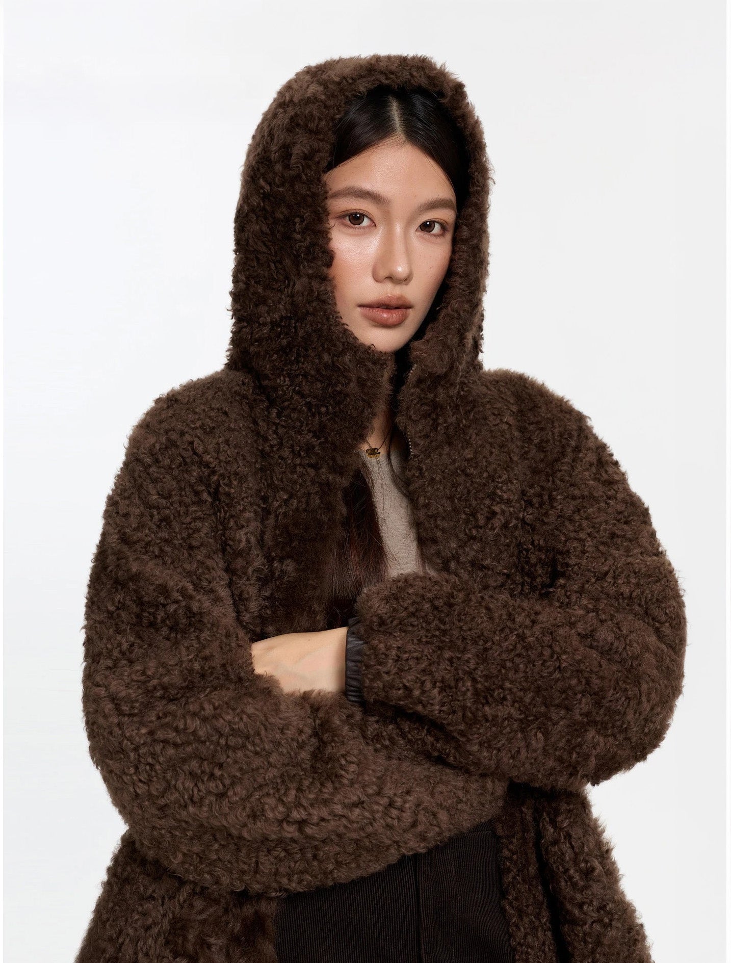 Model with hood up, wearing the Toffee Bloom coat reversed to fur side — From Borcelleclothes.