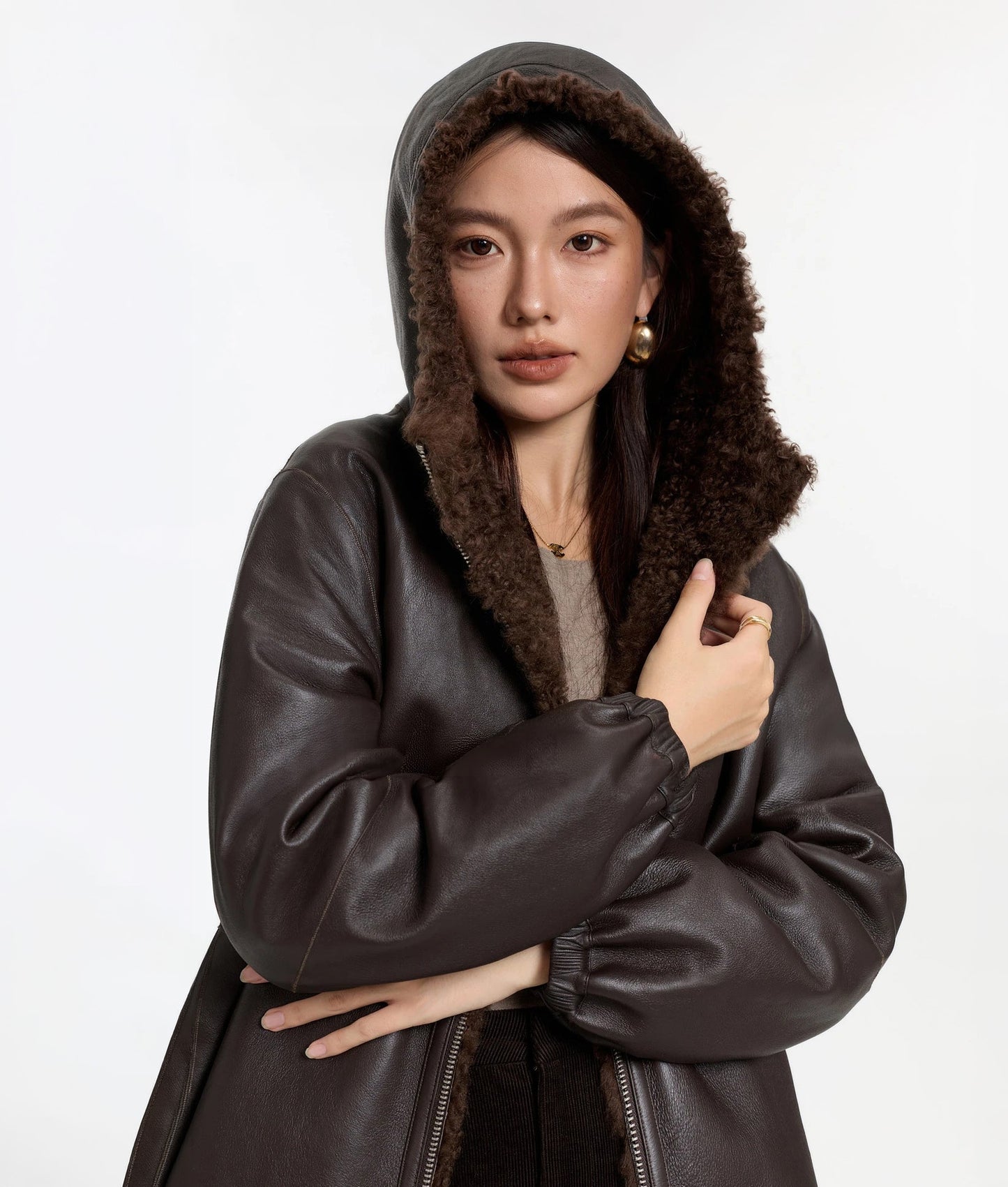 Model with hood up, wearing the Toffee Bloom shearling coat, leather side — From Borcelleclothes.