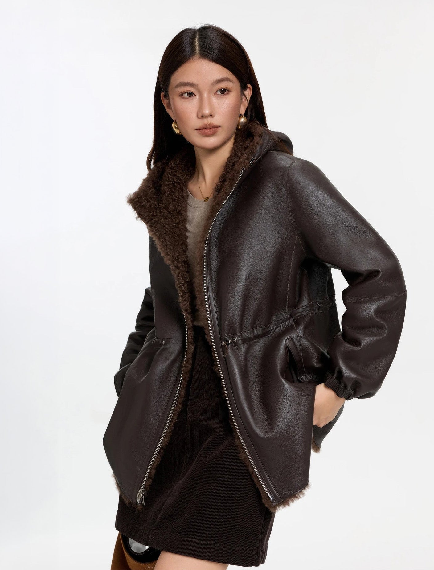 Model turned slightly to the side, Toffee Bloom coat, leather side — From Borcelleclothes.