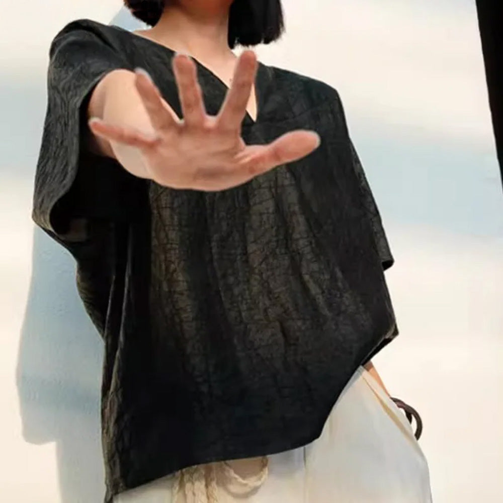 Model in the Beyond Control Xiangyunsha silk top extending a palm-forward gesture toward the camera — From Borcelleclothes.