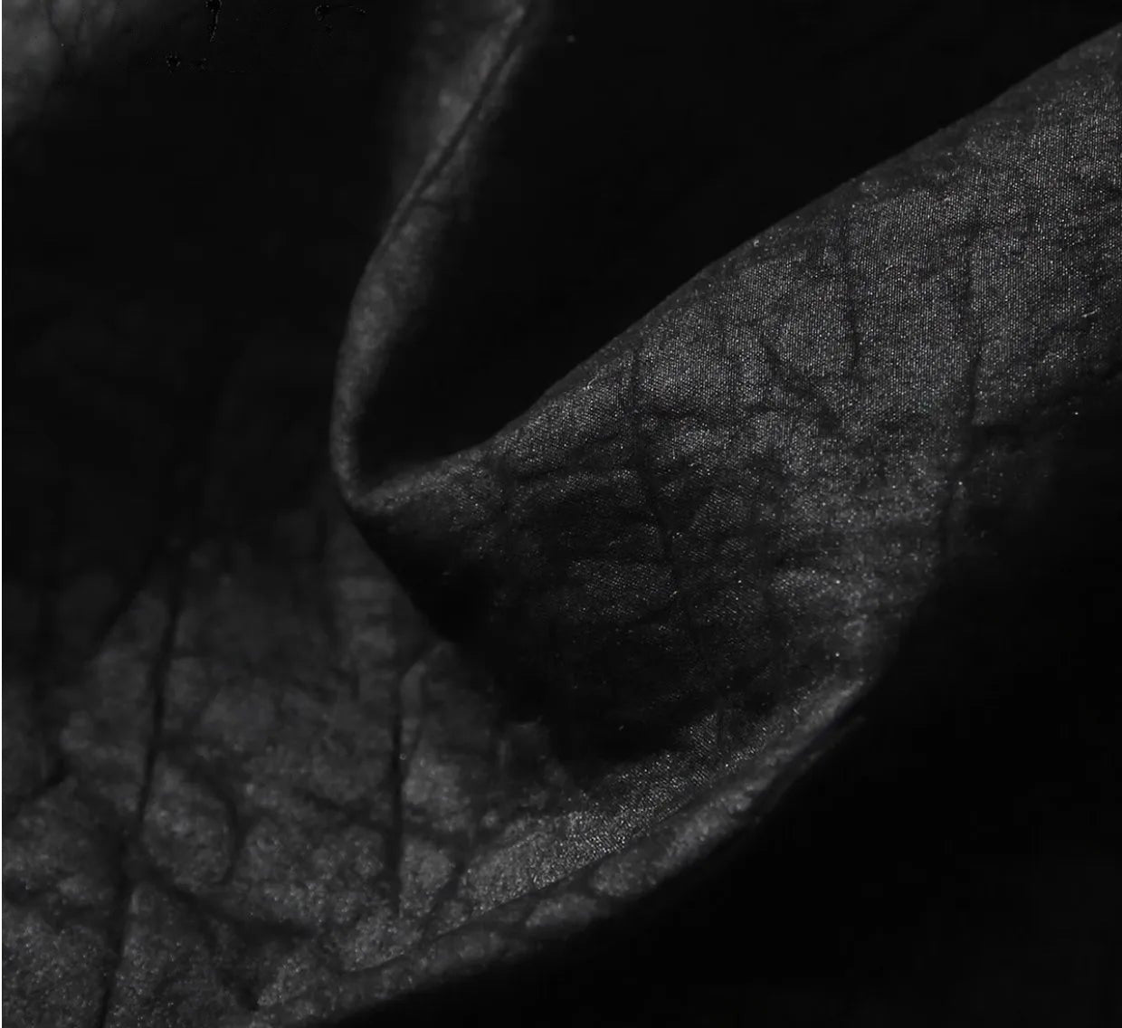 Macro close-up of the artisanal craquelure texture and mineralized finish on the Beyond Control Xiangyunsha silk fabric — From Borcelleclothes.