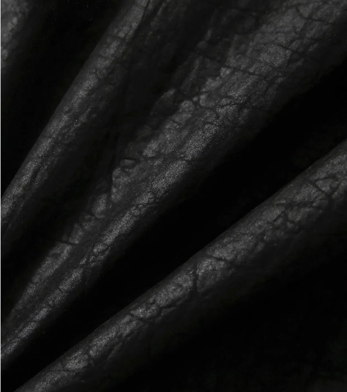 Textile detail highlighting the soft, wave-like folds and light reflection of the Beyond Control crackled silk fabric — From Borcelleclothes.