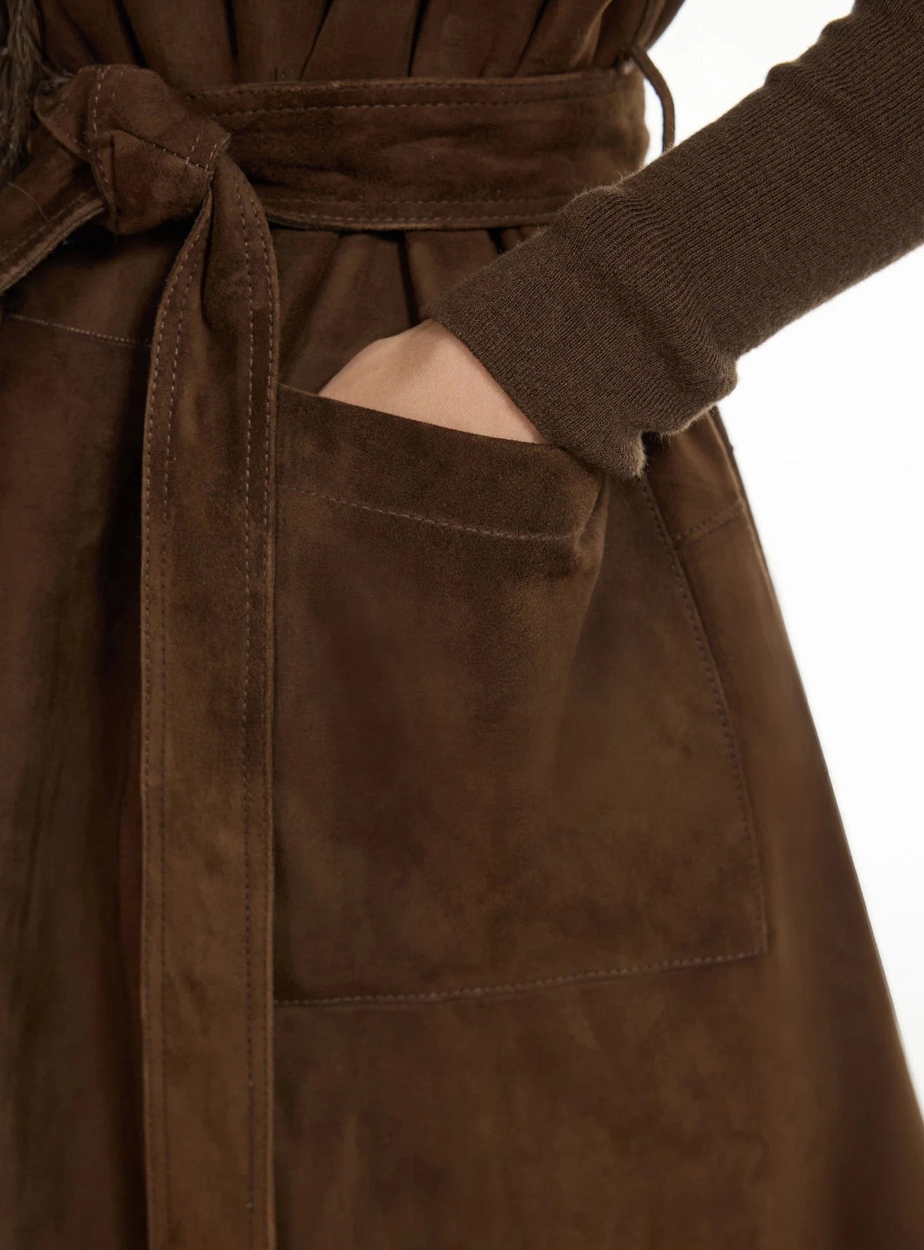 Detail view of hand placed in goatskin jacket pocket, showing suede texture — From Borcelleclothes.