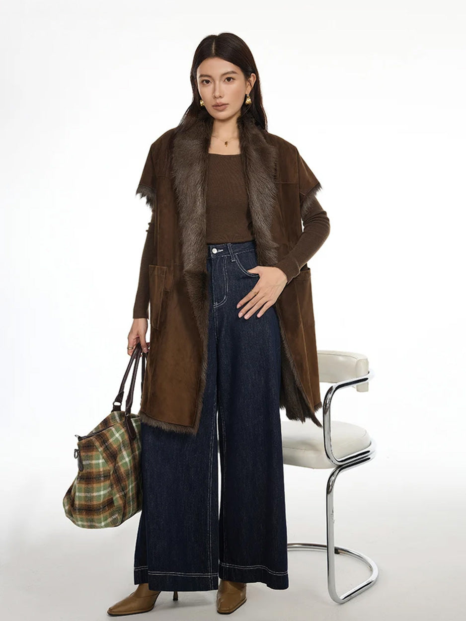 Model wearing goatskin jacket with kimono sleeves in Coffeehouse Chocolate, holding a plaid handbag — From Borcelleclothes.