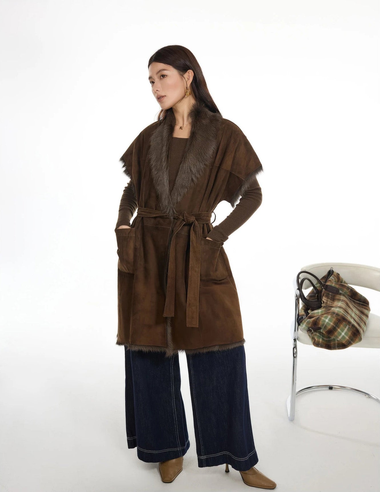 Model looking to the side with hands in pockets, wearing goatskin kimono-sleeve jacket — From Borcelleclothes.