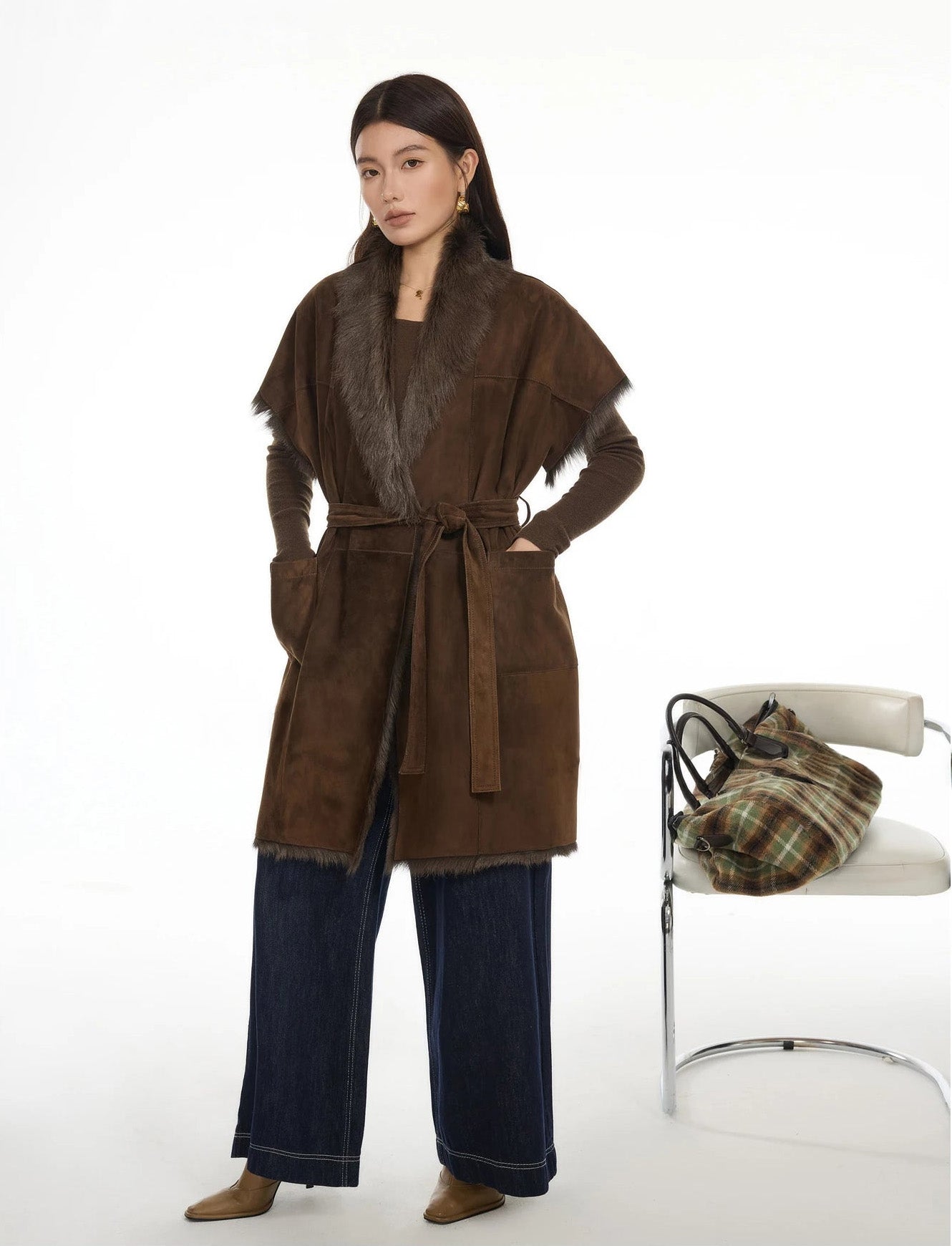 Model standing near a chair with a bag on it, wearing goatskin jacket in Coffeehouse Chocolate — From Borcelleclothes.