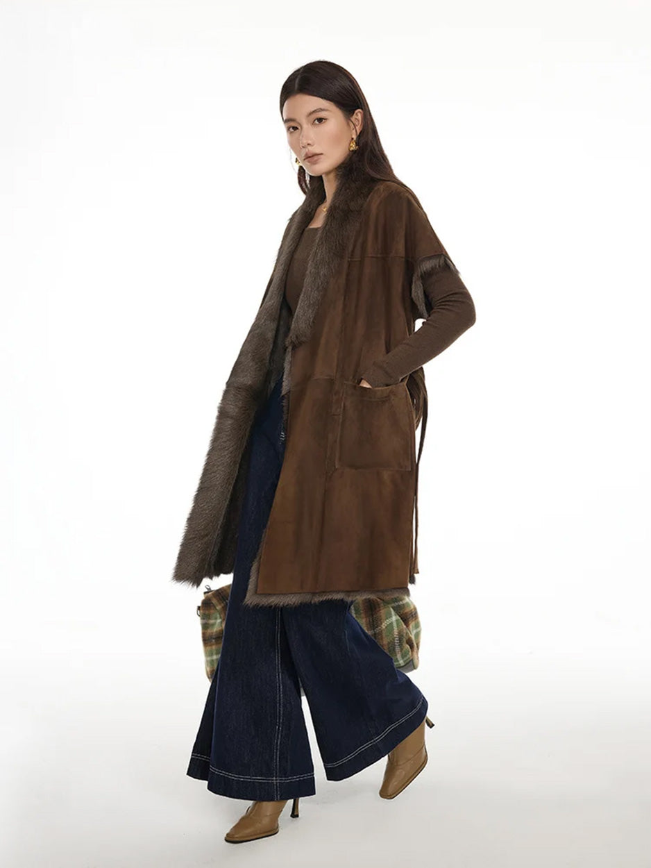 Side view of model walking in Coffeehouse Chocolate goatskin jacket with soft wrap silhouette — From Borcelleclothes.