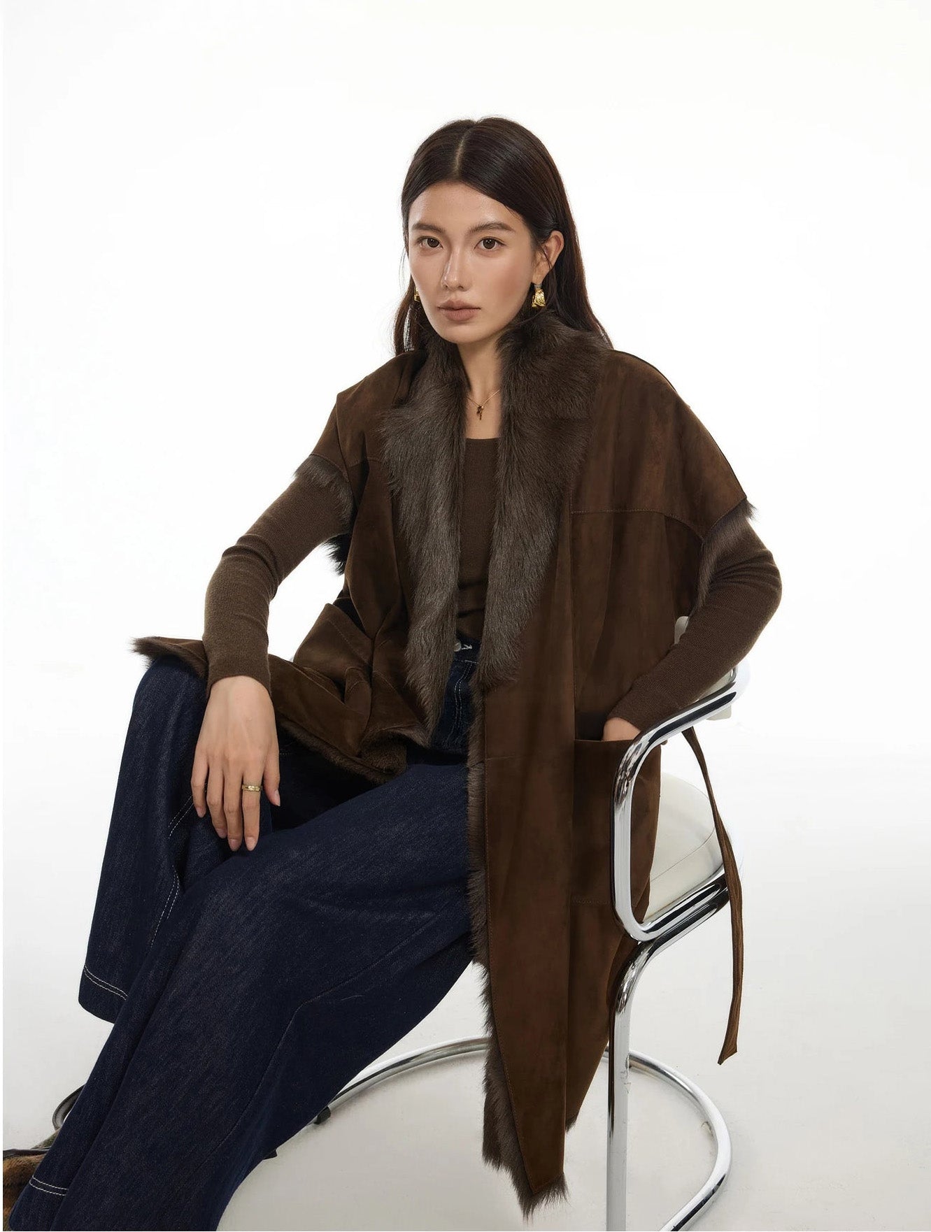 Model sitting with one hand tucked into jacket pocket, showing shawl collar and kimono sleeve — From Borcelleclothes.