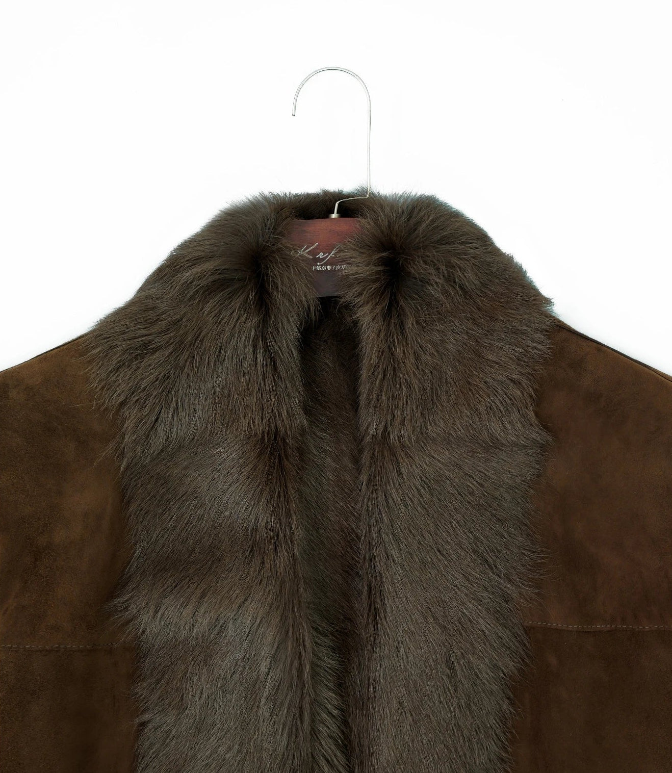 Jacket hanging on a hanger, upper part visible with shawl collar and inner fur — From Borcelleclothes.