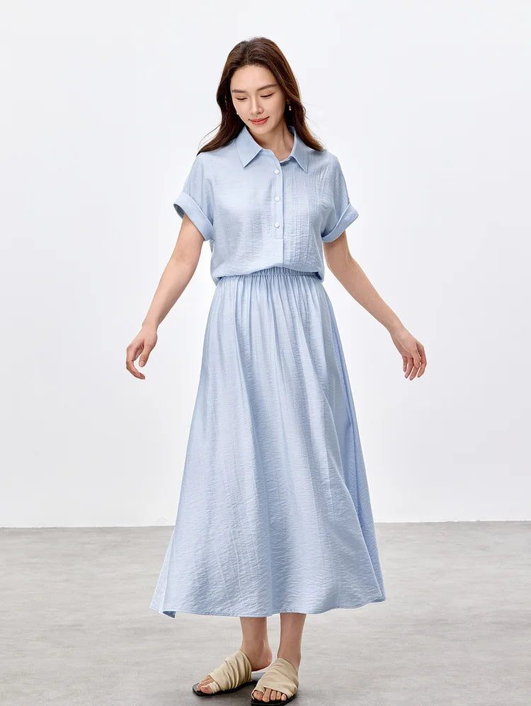 Motion shot of a woman in a Forget-Me-Not Mist set, showing the flared midi skirt in movement — From Borcelleclothes.