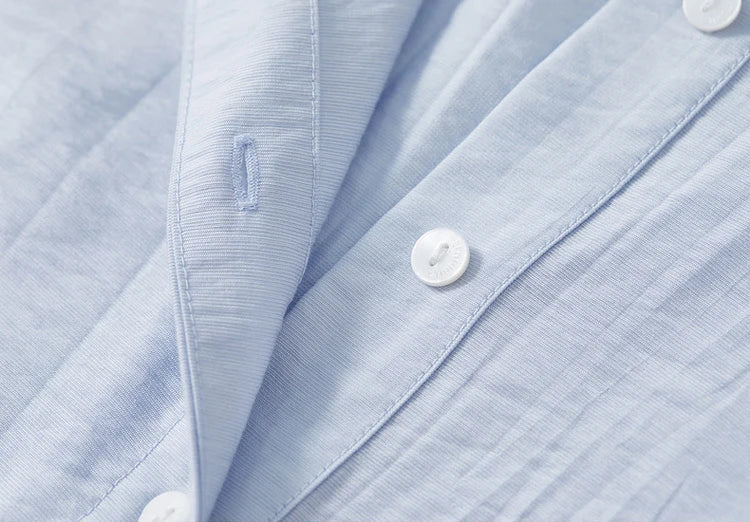 Detail of the tonal buttons and unfastened shirt hem in Forget-Me-Not Mist — From Borcelleclothes.