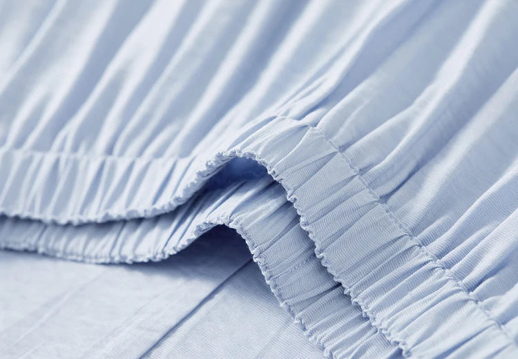 View of the comfortable elasticated waistband on the flared midi skirt — From Borcelleclothes.