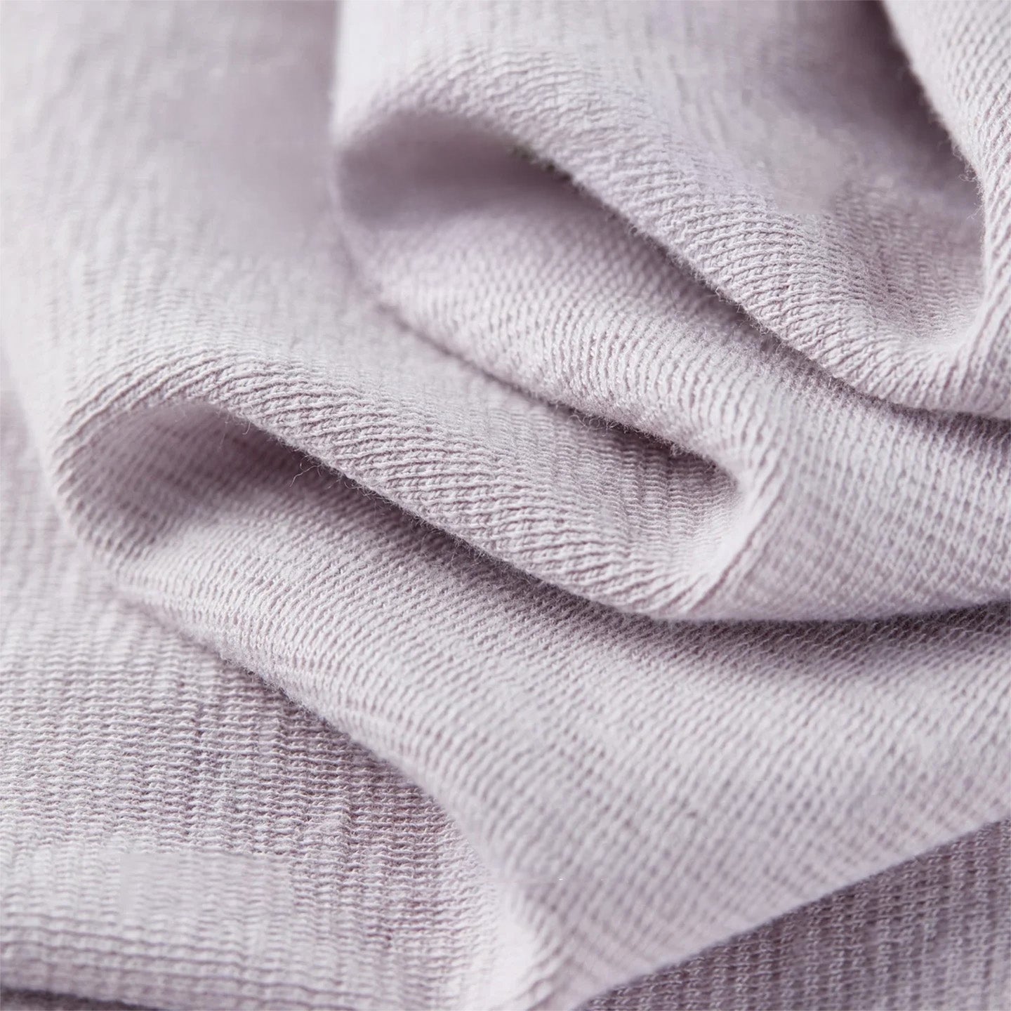 Macro view of the Almost There knit fabric in soft wave-like folds, showing the cotton-viscose blend texture. — From Borcelleclothes.