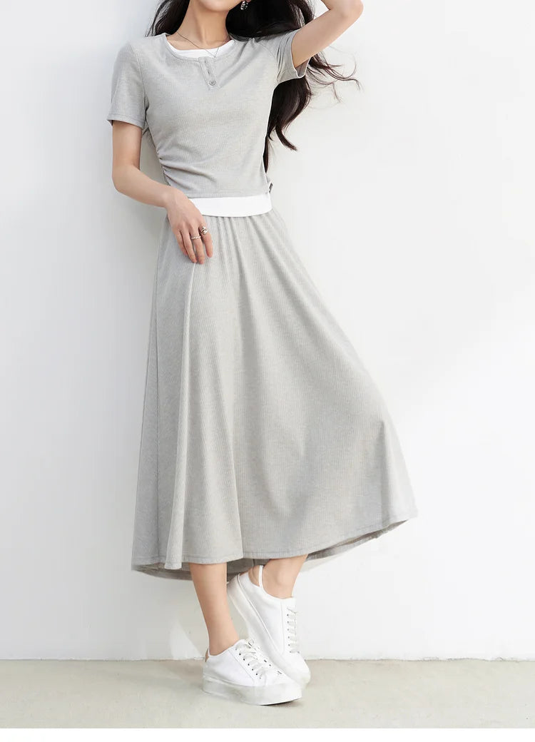 Woman in the Incognito light grey knit set gracefully adjusting her hair — From Borcelleclothes.