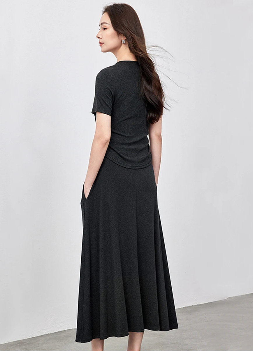 Back view of a woman wearing the Mojo slim-fit top and flared midi skirt — From Borcelleclothes.