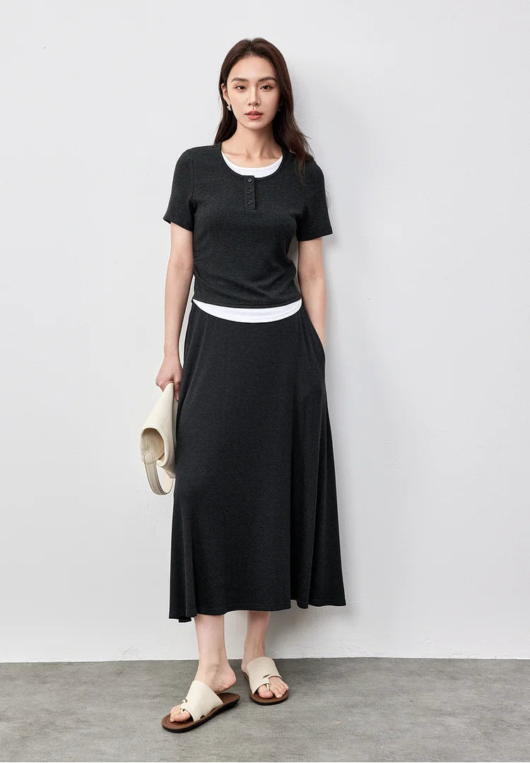 Sophisticated woman with a white bag and her hand in the hidden skirt pocket of the Mojo set — From Borcelleclothes.