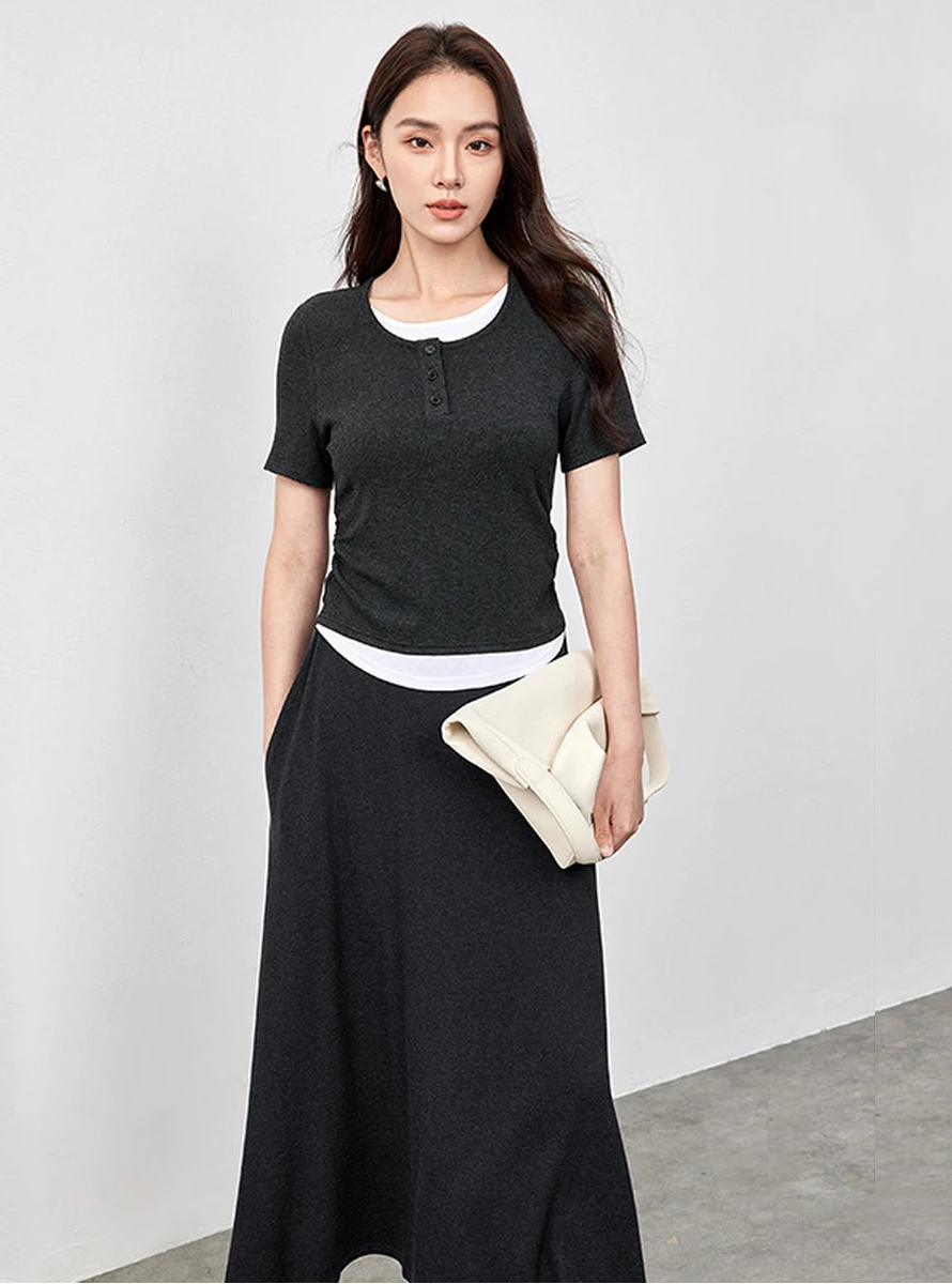 Portrait of a woman looking forward, wearing the Mojo knit set with a hand in her skirt pocket — From Borcelleclothes.