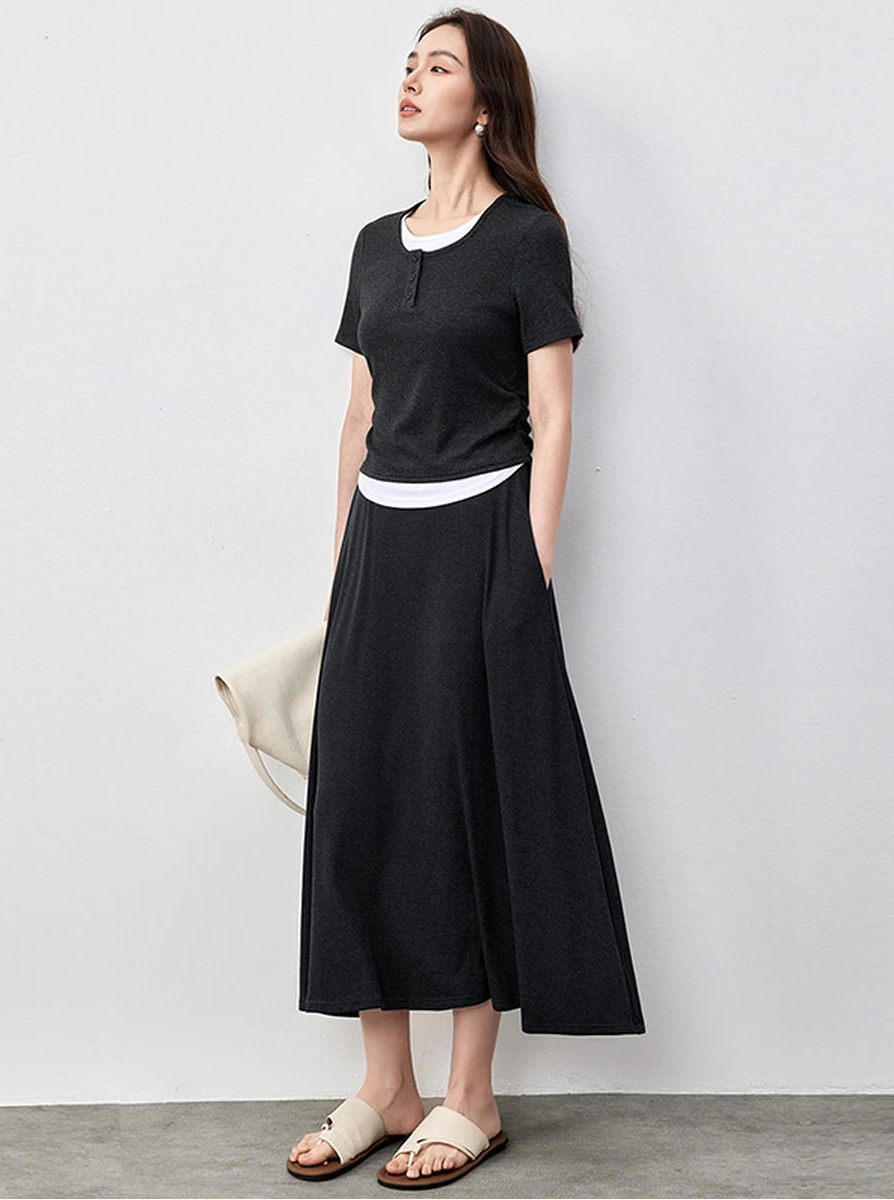 Confident woman in a Mojo dark grey ribbed coordinates looking upwards — From Borcelleclothes.