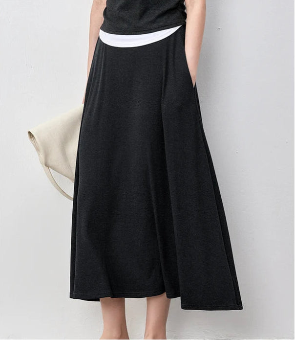 Close-up of a woman wearing the Mojo flared ribbed skirt, showcasing the fabric flow — From Borcelleclothes.
