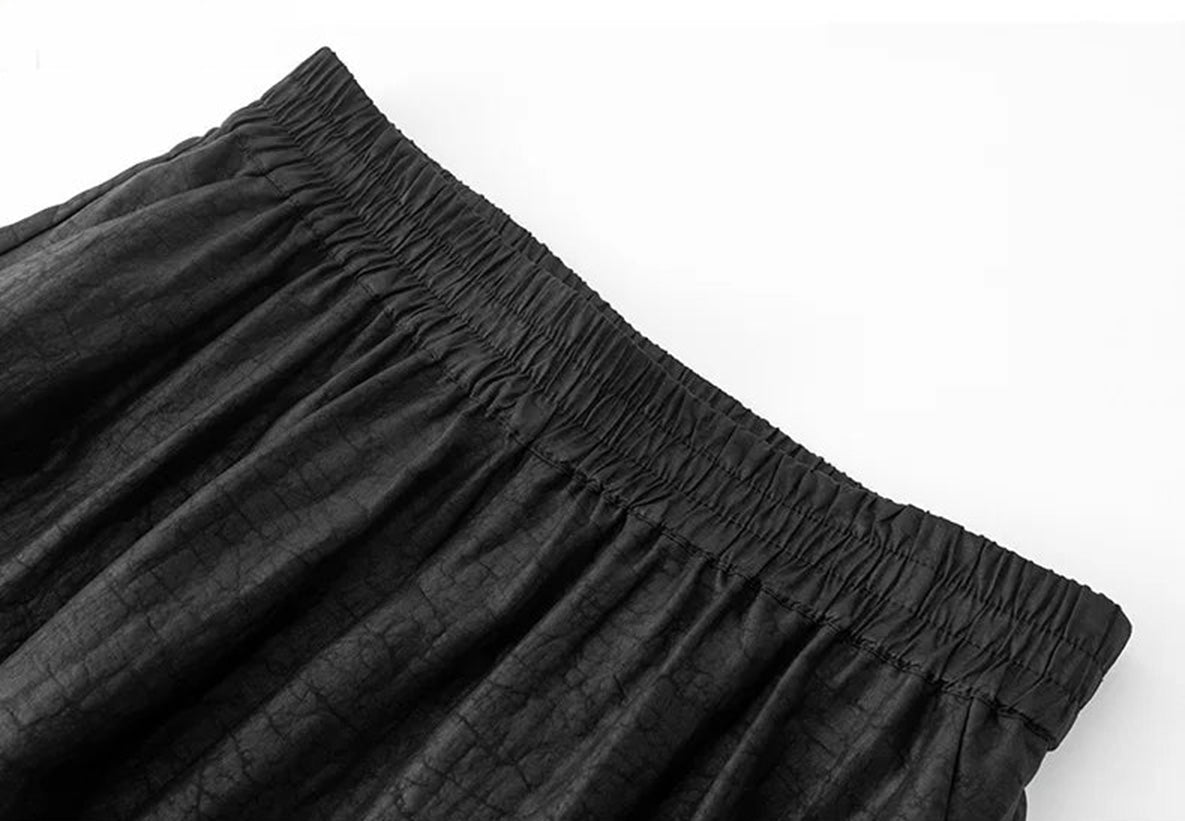 Close-up of the gathered waistband on black Xiangyunsha Mulberry silk lantern pants in Tortoise Ticket — From Borcelleclothes.