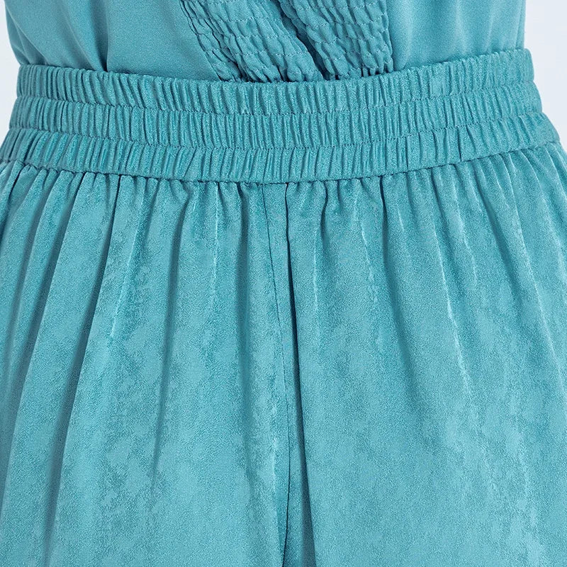 Close-up back view of the trousers on a woman, showing the comfortable elasticated back waistband and fine Mulberry silk finish. — From Borcelleclothes.