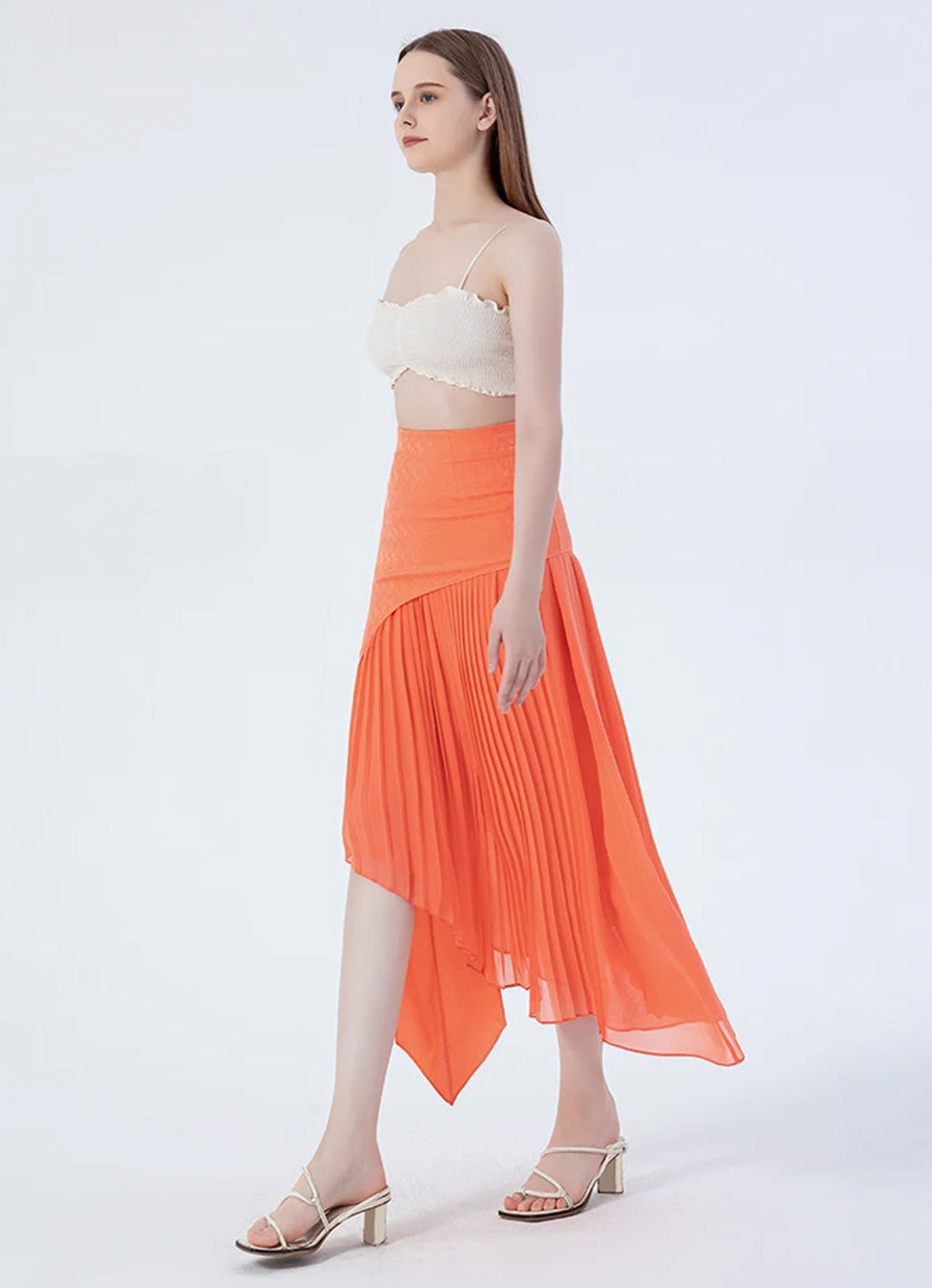 Model turned slightly to the side, highlighting the layered design of a women's asymmetrical Mulberry silk skirt in Veiltail Gold — From Borcelleclothes.