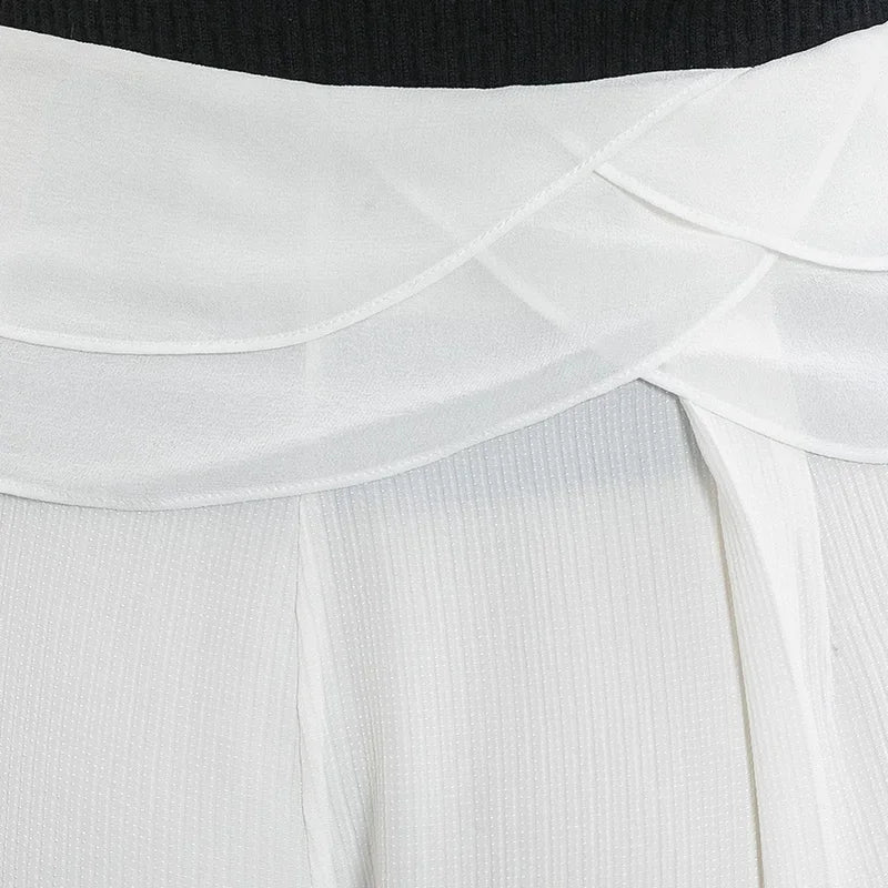 Detailed front view of the draped semi-sheer Georgette waist overlays on No Reward silk trousers — From Borcelleclothes.
