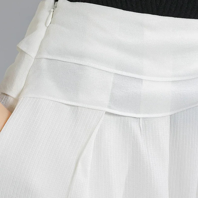 Close-up of the hidden right-side zipper closure nestled beneath the draped waist overlays — From Borcelleclothes.